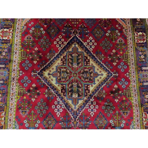 2014 - A RED GROUND DEEP PILE MEIMEH RUGwith multicoloured geometric diamond form central medallion and spa... 