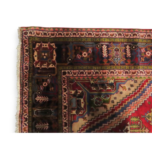 2014 - A RED GROUND DEEP PILE MEIMEH RUGwith multicoloured geometric diamond form central medallion and spa... 