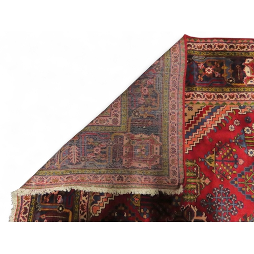 2014 - A RED GROUND DEEP PILE MEIMEH RUGwith multicoloured geometric diamond form central medallion and spa... 