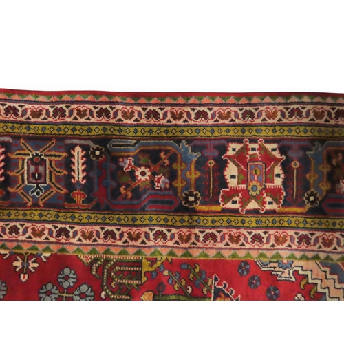 2014 - A RED GROUND DEEP PILE MEIMEH RUGwith multicoloured geometric diamond form central medallion and spa... 