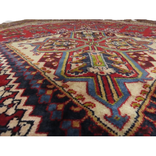 2014 - A RED GROUND DEEP PILE MEIMEH RUGwith multicoloured geometric diamond form central medallion and spa... 