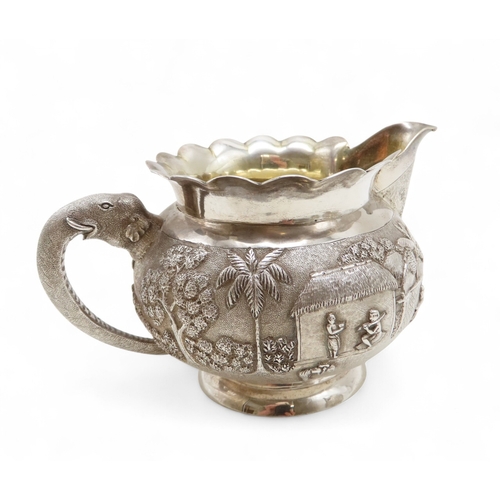 2264 - A CALCUTTA WHITE METAL TEAPOTWith matching cream jug and an associated sugar bowl, the teapot and cr... 