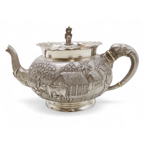 2264 - A CALCUTTA WHITE METAL TEAPOTWith matching cream jug and an associated sugar bowl, the teapot and cr... 