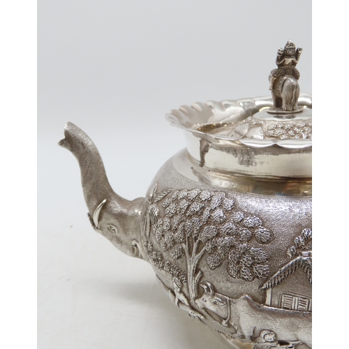 2264 - A CALCUTTA WHITE METAL TEAPOTWith matching cream jug and an associated sugar bowl, the teapot and cr... 