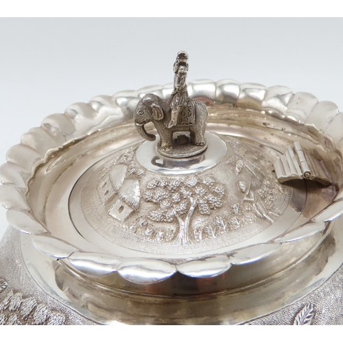 2264 - A CALCUTTA WHITE METAL TEAPOTWith matching cream jug and an associated sugar bowl, the teapot and cr... 