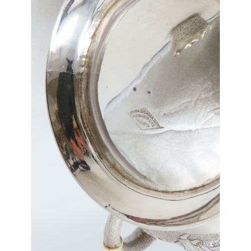 2264 - A CALCUTTA WHITE METAL TEAPOTWith matching cream jug and an associated sugar bowl, the teapot and cr... 