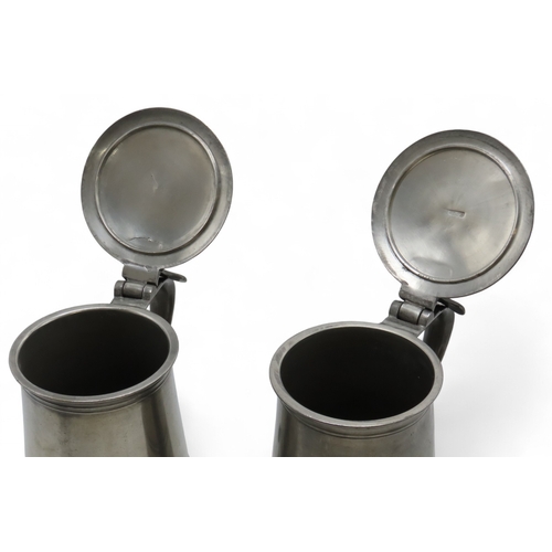 2164 - A PAIR OF SCOTTISH PEWTER FLAT-LID FLAGONS28cm high, together with a pair of large wine goblets, 22c... 