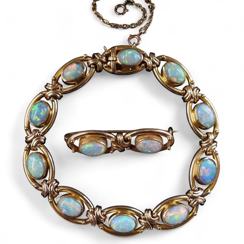 2733 - A 15CT GOLD OPAL BRACELETthe oval links are interspaced with gold knots, very lively opals, with ful... 