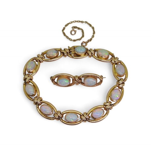 2733 - A 15CT GOLD OPAL BRACELETthe oval links are interspaced with gold knots, very lively opals, with ful... 