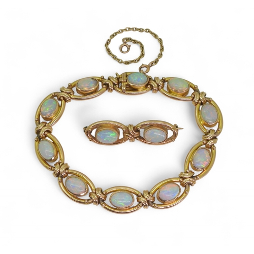 2733 - A 15CT GOLD OPAL BRACELETthe oval links are interspaced with gold knots, very lively opals, with ful... 