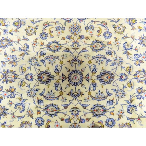 2004 - AN IVORY GROUND FINE KASHAN RUGwith all over floral/foliate patterned ground within beige flower hea... 