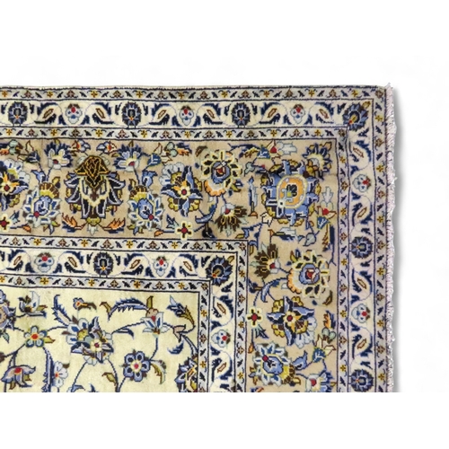 2004 - AN IVORY GROUND FINE KASHAN RUGwith all over floral/foliate patterned ground within beige flower hea... 