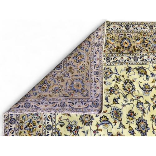 2004 - AN IVORY GROUND FINE KASHAN RUGwith all over floral/foliate patterned ground within beige flower hea... 