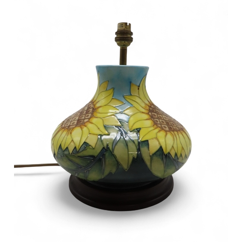 2192 - A MOORCROFT SUNFLOWERS TABLE LAMPof squat baluster form, upon wooden base, 30cm high including fitti... 