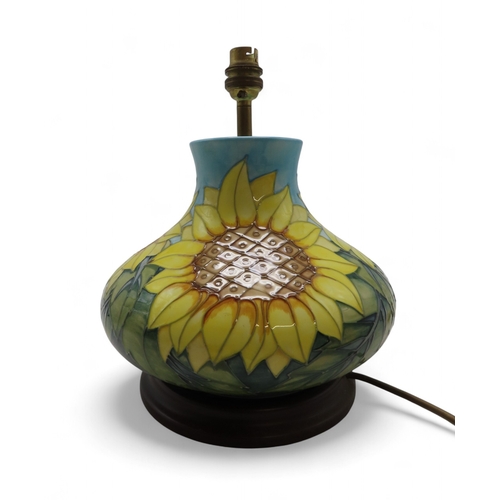 2192 - A MOORCROFT SUNFLOWERS TABLE LAMPof squat baluster form, upon wooden base, 30cm high including fitti... 