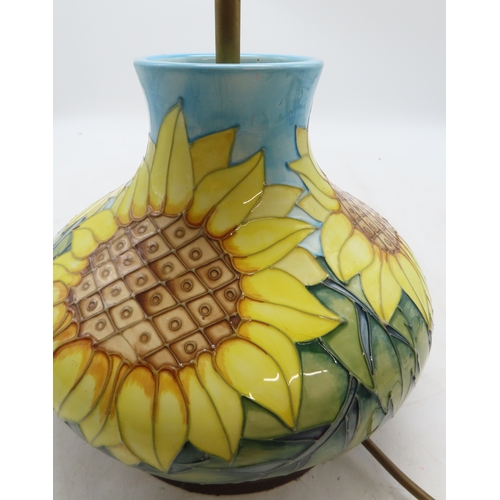 2192 - A MOORCROFT SUNFLOWERS TABLE LAMPof squat baluster form, upon wooden base, 30cm high including fitti... 