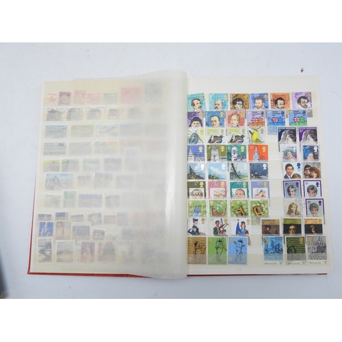 7130 - A worldwide stamp collection in four stock books together with an album of first day covers