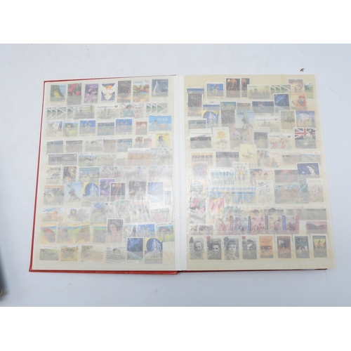 7130 - A worldwide stamp collection in four stock books together with an album of first day covers