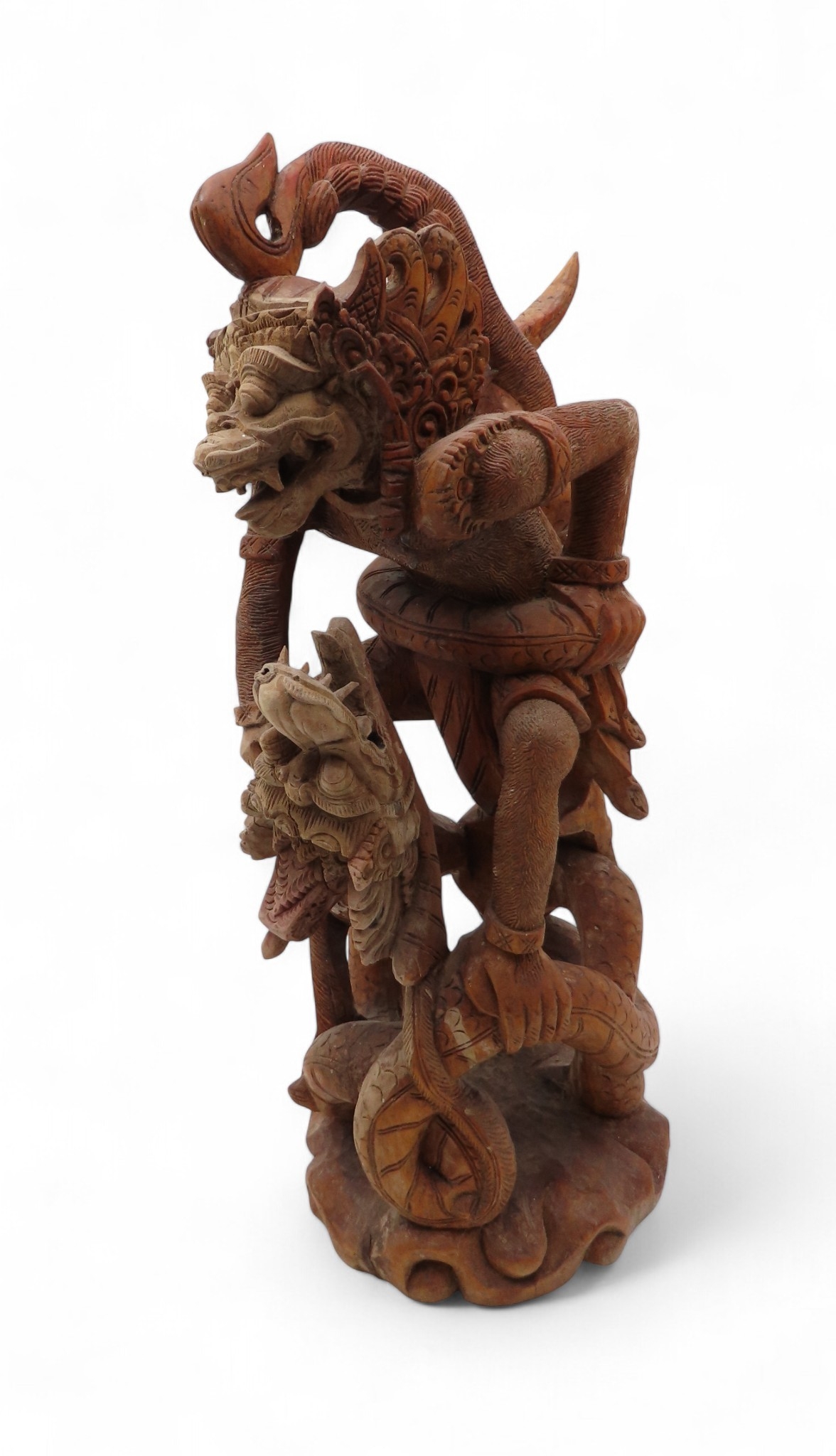 A carved wooden grotesque beast head wall plaque and a carved of a ...