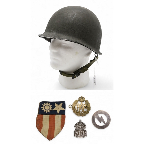 An American M1 pattern steel helmet, with fibre liner marked 