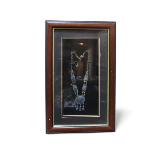 401 - A framed Saudi Arabian white metal breast piece, a lapis lazuli necklace and a Jambiya dagger&nbsp;