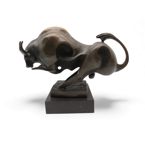 416 - After Miguel Fernando Lopez a contemporary bronze figure of a charging bull, on a black marble base,... 