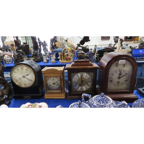 424A - A Kienzle dome top mantle clock with silvered face and three other clocks