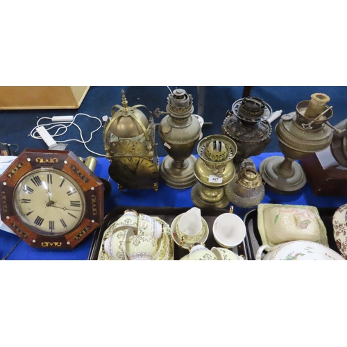 427 - A wag at the wa, a lantern clock and assorted oil lamp bases