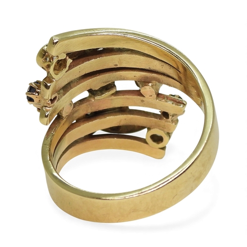 A unique dress ring, made in 9ct gold and studded with diamonds rubies ...