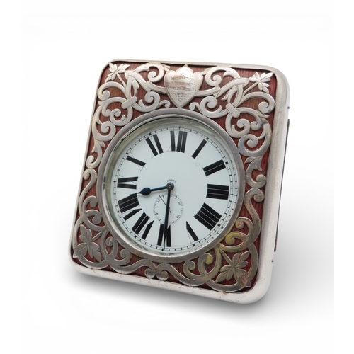 A silver-mounted travelling eight days clock, maker's mark LB, Birmingham, the escutcheon engraved 'SOUVENIR LAUNCH OF EARL OF DOUGLAS', the clock a goliath pocket watch, 15 x 13cm