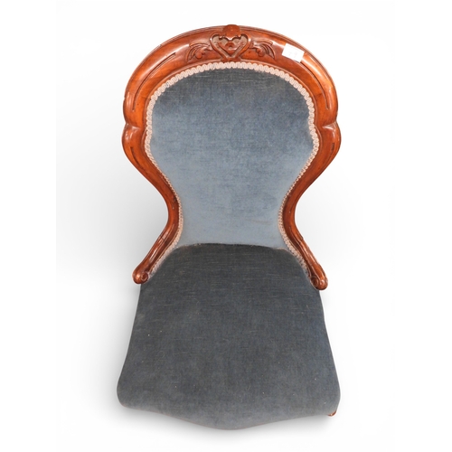 49 - A Victorian walnut framed spoon back nursing chair with blue velveteen upholstery on carved shaped f... 