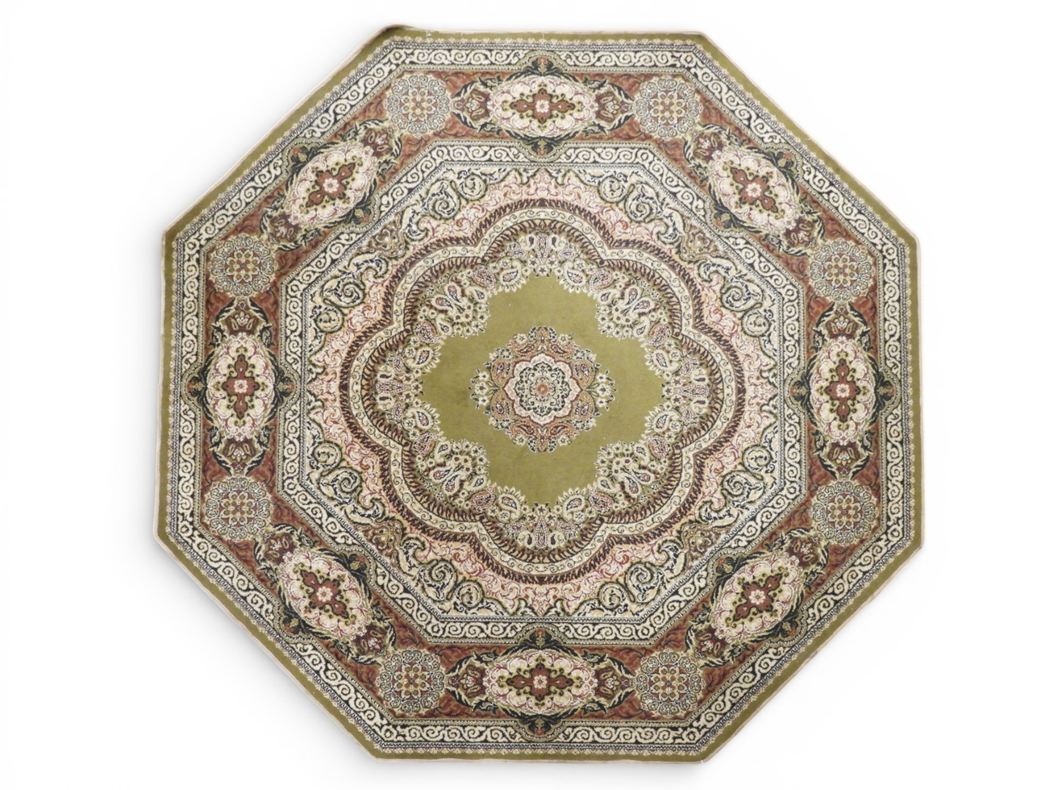 A green ground octagonal Persian style rug with floral patterned ...