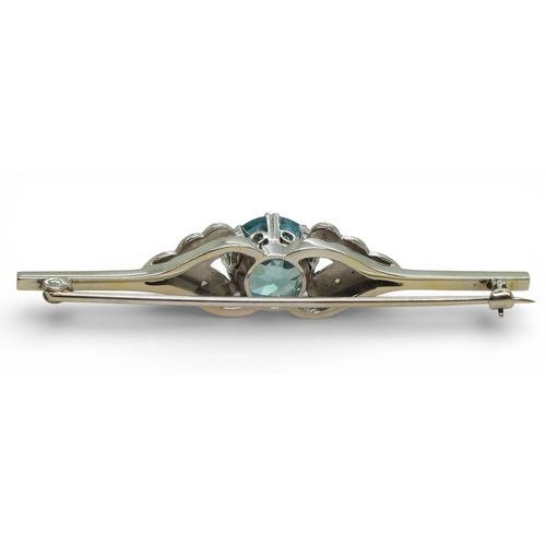 2701 - A BLUE ZIRCON & DIAMOND BROOCHthe mount in white metal with safety clasp, length 5cm, diameter o... 