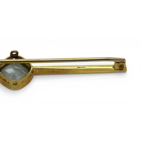 2706 - THREE VINTAGE BROOCHESa yellow metal bar brooch set with a blue glass gem, faintly stamped with a ha... 