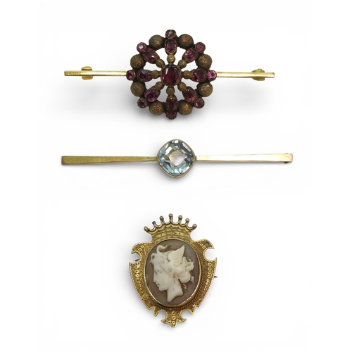 2706 - THREE VINTAGE BROOCHESa yellow metal bar brooch set with a blue glass gem, faintly stamped with a ha... 