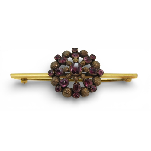 2706 - THREE VINTAGE BROOCHESa yellow metal bar brooch set with a blue glass gem, faintly stamped with a ha... 