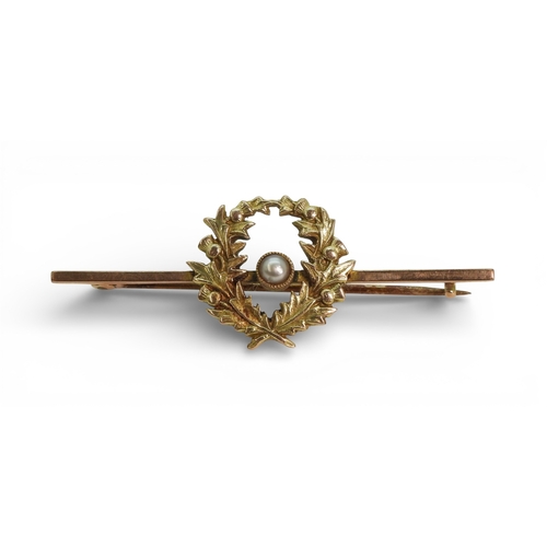 2712 - THREE BROOCHESa 9ct gold bar brooch set with a pearl surrounded with a wreath of thistles, length 5c... 