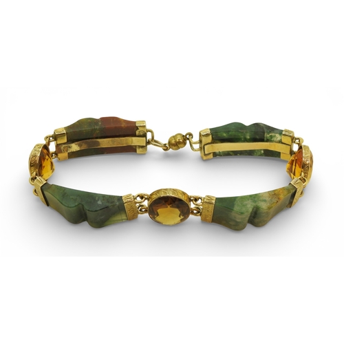 2714 - A SCOTTISH AGATE BRACELETwith carved agate panels mounted in yellow metal and further set with citri... 
