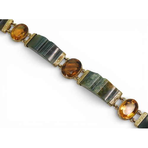 2714 - A SCOTTISH AGATE BRACELETwith carved agate panels mounted in yellow metal and further set with citri... 