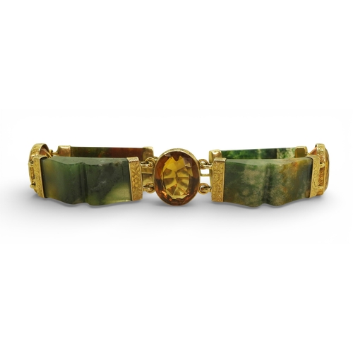 2714 - A SCOTTISH AGATE BRACELETwith carved agate panels mounted in yellow metal and further set with citri... 