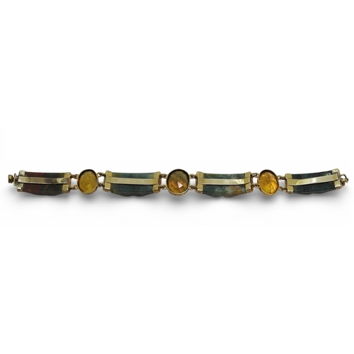2714 - A SCOTTISH AGATE BRACELETwith carved agate panels mounted in yellow metal and further set with citri... 