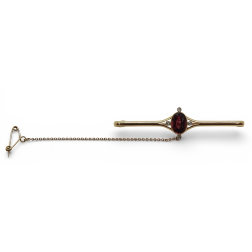 2715 - A GARNET & DIAMOND BROOCHmounted in 15ct gold set with a 10mm x 7.5mm facet cut garnet and four ... 