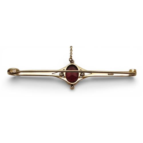 2715 - A GARNET & DIAMOND BROOCHmounted in 15ct gold set with a 10mm x 7.5mm facet cut garnet and four ... 