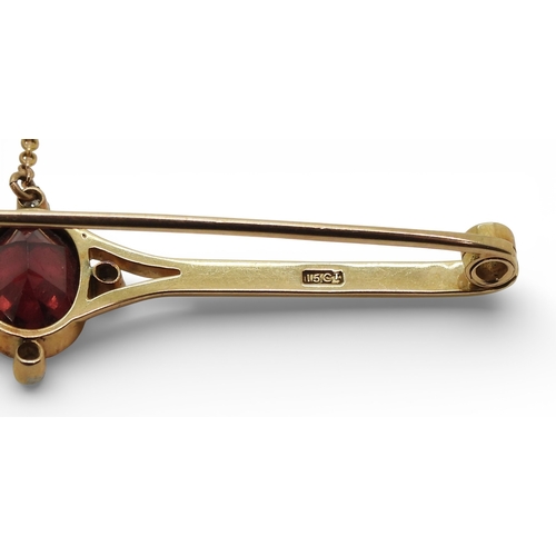 2715 - A GARNET & DIAMOND BROOCHmounted in 15ct gold set with a 10mm x 7.5mm facet cut garnet and four ... 