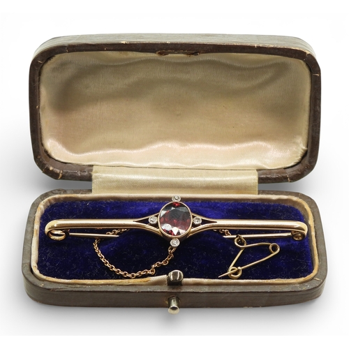 2715 - A GARNET & DIAMOND BROOCHmounted in 15ct gold set with a 10mm x 7.5mm facet cut garnet and four ... 