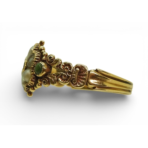 2716 - A GEORGIAN STYLE RINGmounted in yellow metal the shoulders with shell and flower details, set with a... 