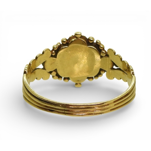 2716 - A GEORGIAN STYLE RINGmounted in yellow metal the shoulders with shell and flower details, set with a... 
