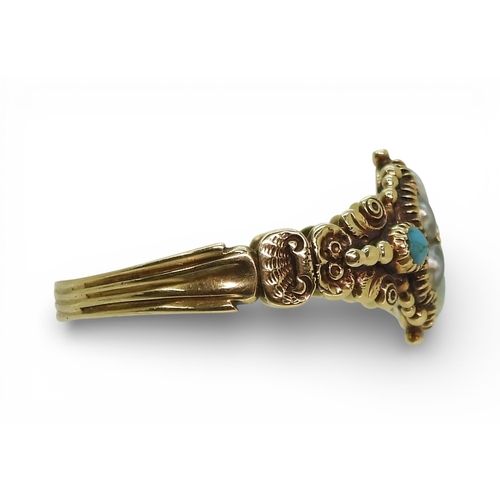 2716 - A GEORGIAN STYLE RINGmounted in yellow metal the shoulders with shell and flower details, set with a... 