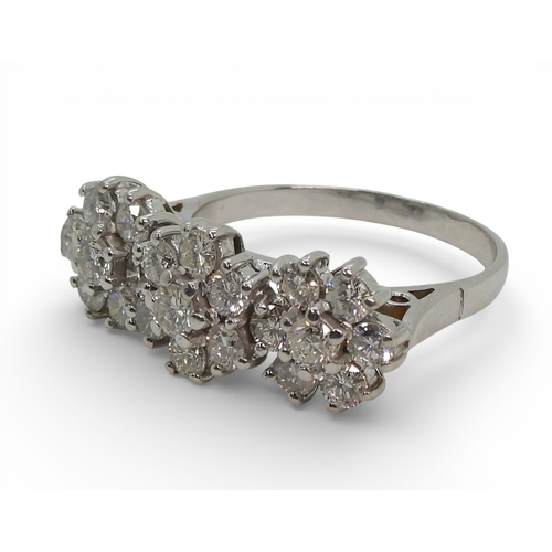 2717 - A RING OF THREE FLOWERSset in 18ct white gold and set with estimated approx 1.60cts of brilliant cut... 