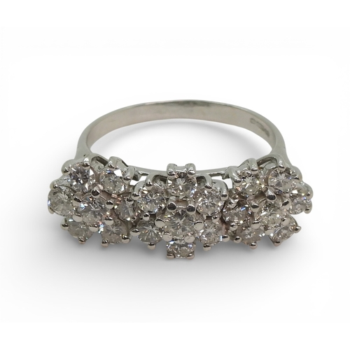 2717 - A RING OF THREE FLOWERSset in 18ct white gold and set with estimated approx 1.60cts of brilliant cut... 